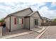 Rear view of home features neutral siding, a sliding glass door, and low maintenance rock landscaping at 9643 Birch Ln, Thornton, CO 80229