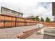 Backyard has tiered stone accents, low-maintenance landscaping, and a tall fence offering privacy at 9643 Birch Ln, Thornton, CO 80229