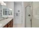 Bathroom featuring a shower with glass door and a granite vanity top at 9643 Birch Ln, Thornton, CO 80229