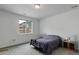 Neutral bedroom features a large window, carpet flooring, and comfortable furnishings at 9643 Birch Ln, Thornton, CO 80229