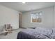 Bright bedroom featuring a large window with a view and neutral decor at 9643 Birch Ln, Thornton, CO 80229
