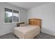 Cozy bedroom featuring a large window with natural light and carpet floors at 9643 Birch Ln, Thornton, CO 80229