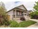 Attractive home with a covered front porch, manicured lawn, and easy access to the attached garage at 9643 Birch Ln, Thornton, CO 80229