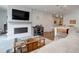 Cozy living room with fireplace, built-in media center, and open access to the kitchen at 9643 Birch Ln, Thornton, CO 80229