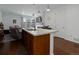 Open-concept living space featuring a kitchen island, hardwood floors, and sliding door at 9643 Birch Ln, Thornton, CO 80229