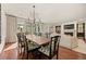 Elegant dining area with a chandelier, large table, and stylish seating adjacent to the living room at 344 Saint Paul St, Denver, CO 80206