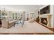 Open-concept living room with a fireplace, sliding glass doors, and modern decor at 344 Saint Paul St, Denver, CO 80206