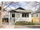 Charming, renovated bungalow with freshly painted white brick and beautifully landscaped front yard at 1018 Fillmore St, Denver, CO 80206