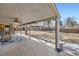 Covered patio with ceiling fan, overlooking a large backyard at 7023 S Buffalo St, Littleton, CO 80120