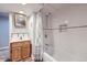 Clean basement bathroom with shower/tub and wood flooring at 7023 S Buffalo St, Littleton, CO 80120