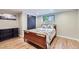 Finished basement bedroom with wood flooring and a window at 7023 S Buffalo St, Littleton, CO 80120