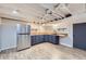 Basement kitchenette with modern cabinetry and stainless steel refrigerator at 7023 S Buffalo St, Littleton, CO 80120