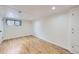 Spacious finished basement room, featuring light wood flooring and recessed lighting at 7023 S Buffalo St, Littleton, CO 80120