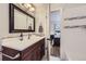 Bathroom with vanity, mirror, and shower/tub at 7023 S Buffalo St, Littleton, CO 80120