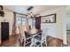 Bright dining room with wooden table, white chairs, and rustic chandelier at 7023 S Buffalo St, Littleton, CO 80120