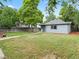 Spacious backyard with mature trees, a lush lawn, and a charming exterior at 4232 S Grant St, Englewood, CO 80113