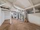 Unfinished basement with exposed beams, carpet, and modern washer and dryer units at 4232 S Grant St, Englewood, CO 80113