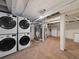 Basement laundry area with stacked washer/dryer units and utility hookups at 4232 S Grant St, Englewood, CO 80113