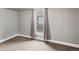 Comfortable bedroom with neutral walls, carpet, and a large window offering natural light at 4232 S Grant St, Englewood, CO 80113