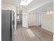 Open dining area featuring wood floors, a skylight, and access to the kitchen and other rooms at 4232 S Grant St, Englewood, CO 80113