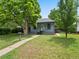 Inviting single-story home with well-maintained lawn and a cozy front porch and an American flag at 4232 S Grant St, Englewood, CO 80113