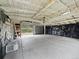 Spacious detached garage with a concrete floor, a partially covered interior, and overhead lighting at 4232 S Grant St, Englewood, CO 80113
