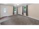 Bright living room featuring neutral walls, gray carpet, and ample natural light from the windows at 4232 S Grant St, Englewood, CO 80113