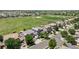 An aerial view of a suburban neighborhood showcasing well-maintained homes and a large community park at 15602 E 117Th Ave, Commerce City, CO 80022