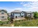 Lovely two-story blue house with a spacious fenced yard, patio, and sliding doors on a sunny day at 15602 E 117Th Ave, Commerce City, CO 80022