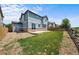 Fenced backyard featuring a stone patio, lawn and garden space for outdoor enjoyment at 15602 E 117Th Ave, Commerce City, CO 80022