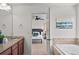 Elegant bathroom with a soaking tub and granite vanity with an adjacent bedroom view at 15602 E 117Th Ave, Commerce City, CO 80022