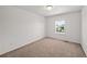 Clean bedroom featuring neutral carpet, white walls, and a window at 15602 E 117Th Ave, Commerce City, CO 80022