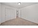 Bedroom with neutral carpet and white walls, featuring closet space at 15602 E 117Th Ave, Commerce City, CO 80022
