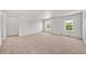 Spacious bonus room with neutral carpet, white walls, and natural light from two windows at 15602 E 117Th Ave, Commerce City, CO 80022
