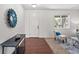 Welcoming entryway with wood floors, stylish decor, and natural light streaming through a window at 15602 E 117Th Ave, Commerce City, CO 80022