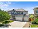 Beautiful two-story home featuring a three-car garage, landscaped yard, and a welcoming covered porch at 15602 E 117Th Ave, Commerce City, CO 80022