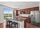 Spacious kitchen island featuring granite countertops and stainless appliances, offering a modern space at 15602 E 117Th Ave, Commerce City, CO 80022