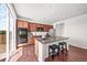 Kitchen with stainless appliances, granite countertops, ample cabinet space, and hardwood floors at 15602 E 117Th Ave, Commerce City, CO 80022