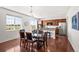 Bright and airy kitchen with stainless steel appliances, granite countertops, and hardwood floors at 15602 E 117Th Ave, Commerce City, CO 80022