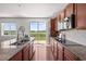 Kitchen with granite countertops, stainless appliances, and sliding door access to the outdoor space at 15602 E 117Th Ave, Commerce City, CO 80022