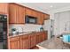 Well-lit kitchen featuring wood cabinets, stainless steel appliances, and granite countertops at 15602 E 117Th Ave, Commerce City, CO 80022