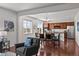 Open-concept living and dining area with hardwood floors, ample natural light, and modern furnishings at 15602 E 117Th Ave, Commerce City, CO 80022