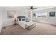 Bright main bedroom with a ceiling fan, a large window, and stylish decor at 15602 E 117Th Ave, Commerce City, CO 80022