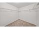 Spacious walk-in closet featuring carpeted floors and wire shelving for organized storage at 15602 E 117Th Ave, Commerce City, CO 80022
