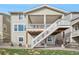 Back of house featuring a spacious two-level deck, perfect for entertaining and outdoor enjoyment at 19076 W 84Th Pl, Arvada, CO 80007