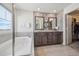 Elegant bathroom features a soaking tub, dual vanity with granite countertop, and stylish accent wall at 19076 W 84Th Pl, Arvada, CO 80007