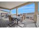 Covered patio features a table with four chairs, string lights, and views of the neighborhood at 19076 W 84Th Pl, Arvada, CO 80007