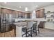 Modern kitchen with granite countertops, stainless appliances, and ample cabinet space at 19076 W 84Th Pl, Arvada, CO 80007