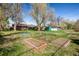 Green backyard featuring a home garden, trees, and well maintained grass at 1542 Kilkenny, Boulder, CO 80303