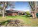 Brick home with a well-kept backyard including established trees and green grass at 1542 Kilkenny, Boulder, CO 80303